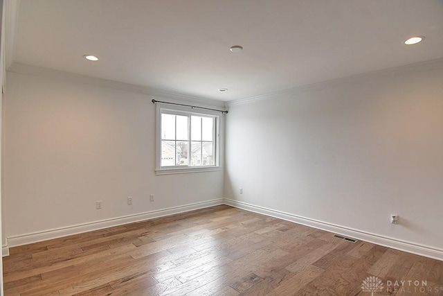 9471 Banyan Ct, Dayton, OH 45458 - spare room featuring baseboards, wood finished floors, visible vents, and crown molding