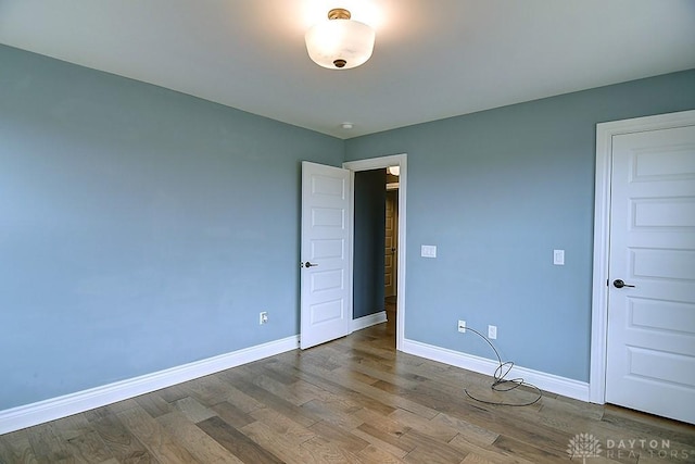 9471 Banyan Ct, Dayton, OH 45458 - unfurnished bedroom with baseboards and wood finished floors