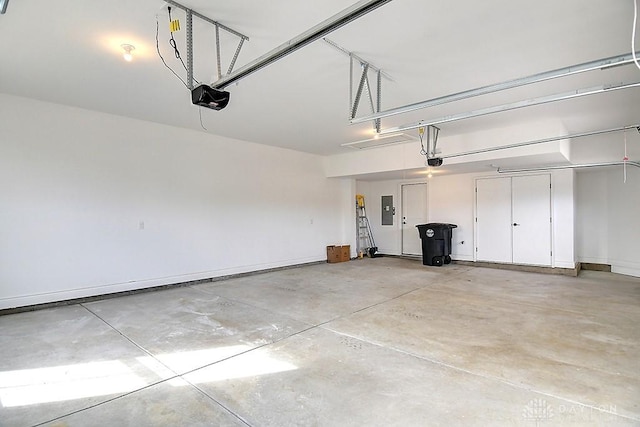 9471 Banyan Ct, Dayton, OH 45458 - garage featuring electric panel, baseboards, and a garage door opener