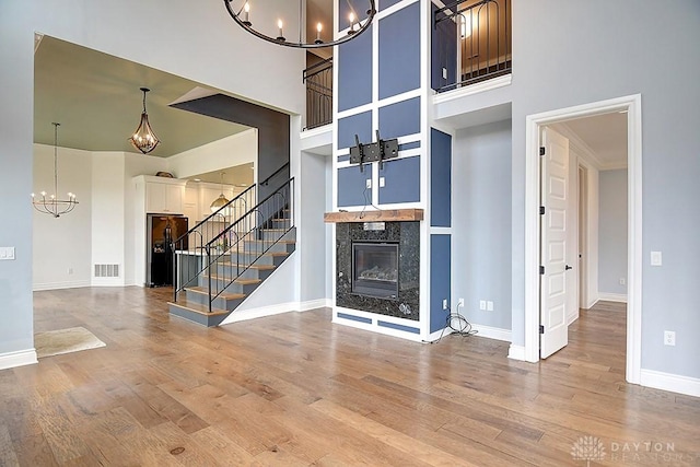 9471 Banyan Ct, Dayton, OH 45458 - foyer entrance featuring an inviting chandelier, stairs, a premium fireplace, and wood finished floors