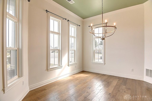 9471 Banyan Ct, Dayton, OH 45458 - unfurnished dining area featuring plenty of natural light, crown molding, baseboards, and wood finished floors