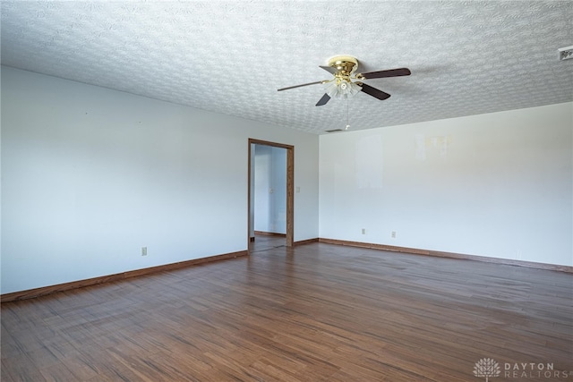 unfurnished room featuring visible vents, baseboards, a ceiling fan, wood finished floors, and a textured ceiling