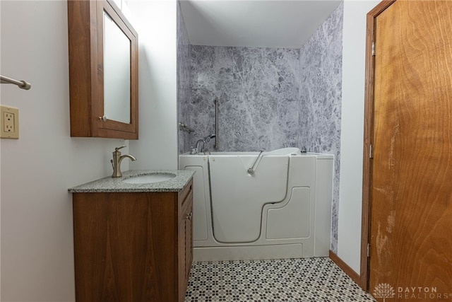 bathroom featuring vanity and a washtub