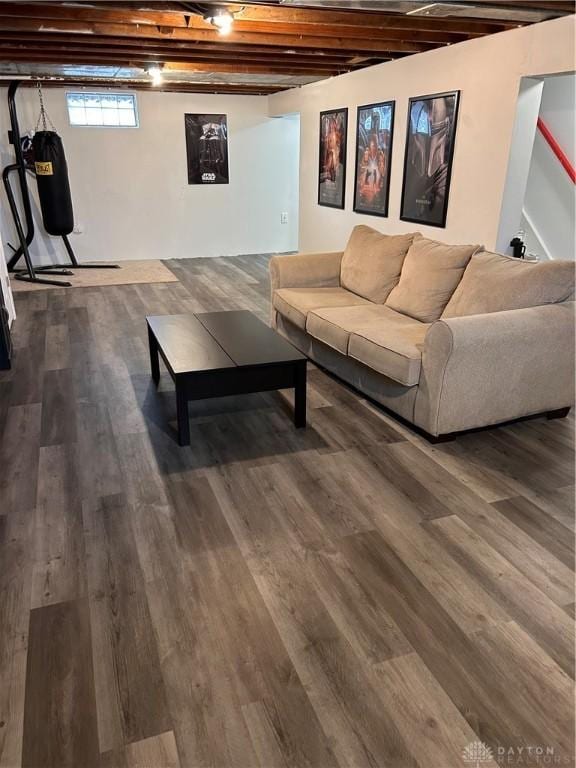 living room featuring dark wood-style floors and beamed ceiling