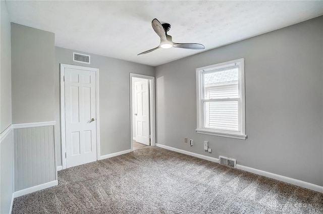 unfurnished bedroom with carpet, visible vents, and baseboards