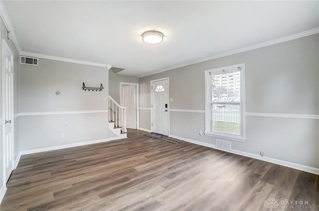 entrance foyer featuring stairway, wood finished floors, visible vents, and crown molding