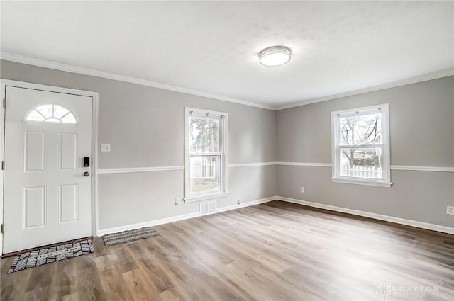 entryway featuring a wealth of natural light, wood finished floors, visible vents, and baseboards