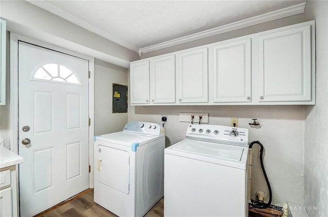 washroom featuring separate washer and dryer, dark wood-type flooring, cabinet space, and electric panel