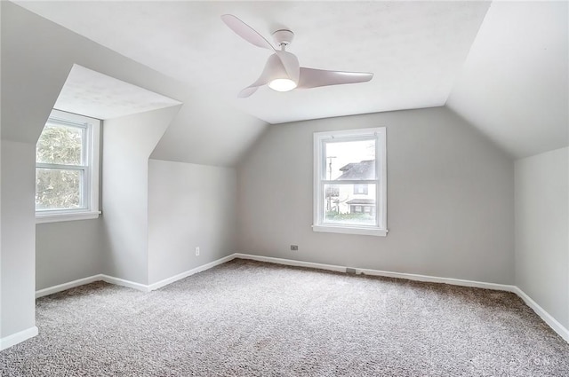 additional living space featuring baseboards, carpet flooring, and a healthy amount of sunlight