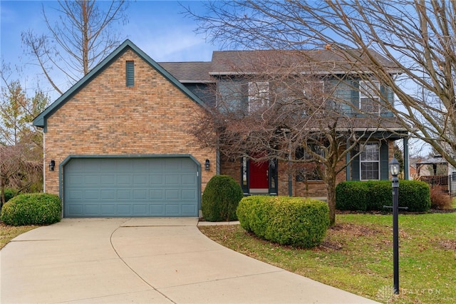 traditional-style home featuring driveway, a front yard, a garage, and brick siding