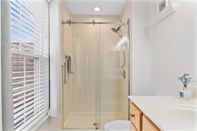 full bath featuring vanity, a shower stall, and toilet