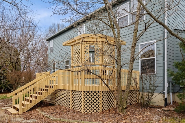 rear view of property with a wooden deck