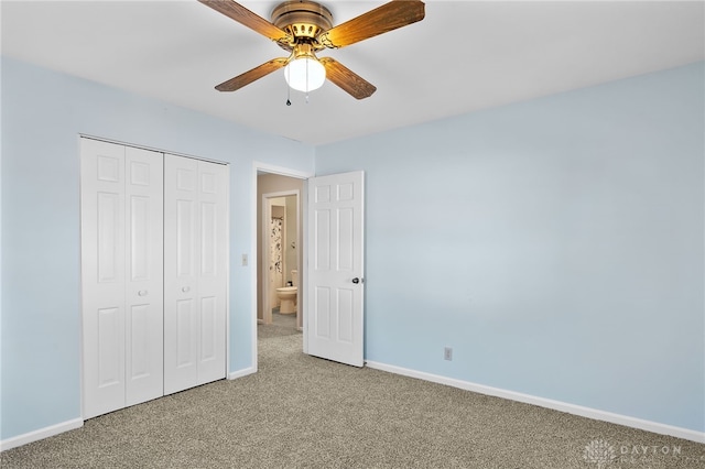 unfurnished bedroom featuring carpet, baseboards, and a closet