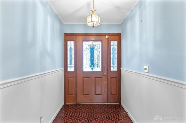 doorway featuring ornamental molding, brick floor, and baseboards