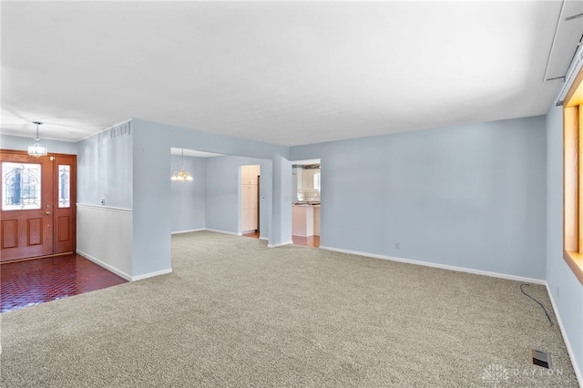 interior space featuring visible vents, baseboards, and an inviting chandelier