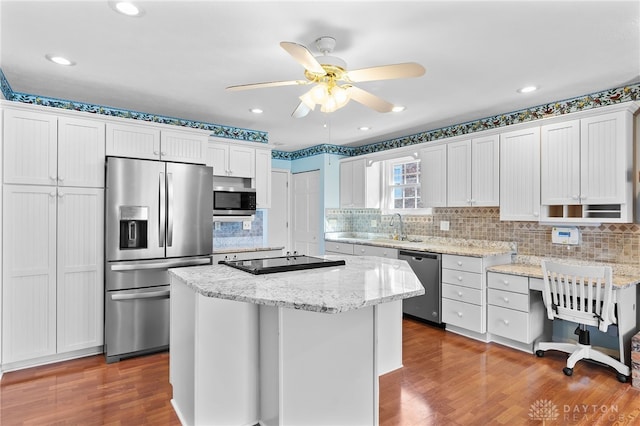 kitchen featuring white cabinetry, appliances with stainless steel finishes, dark wood-style flooring, and a sink