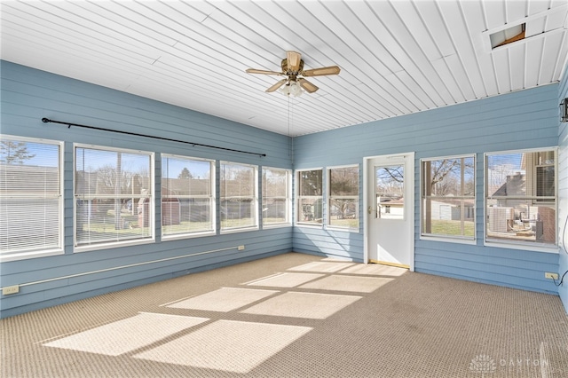 unfurnished sunroom with a ceiling fan and a wealth of natural light