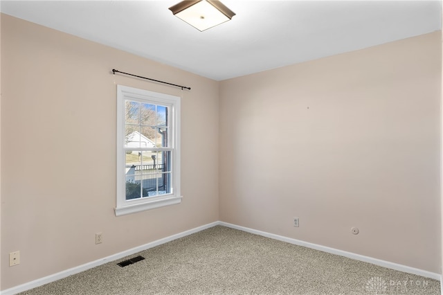 spare room with light carpet, baseboards, and visible vents