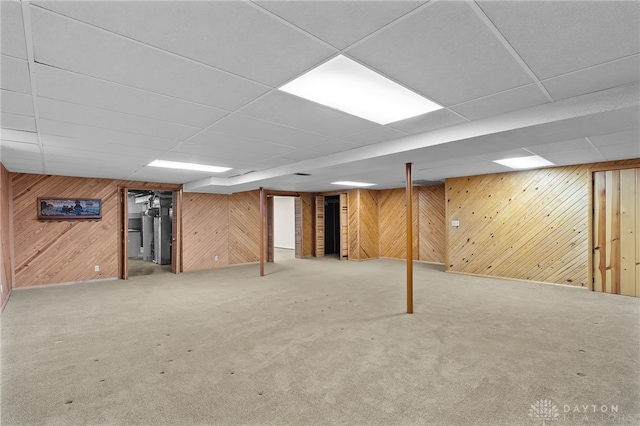 finished basement featuring carpet floors and wood walls