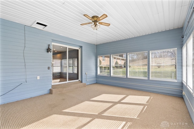 unfurnished sunroom with a ceiling fan