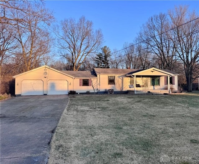 view of front of property with a porch, a front yard, and an attached garage