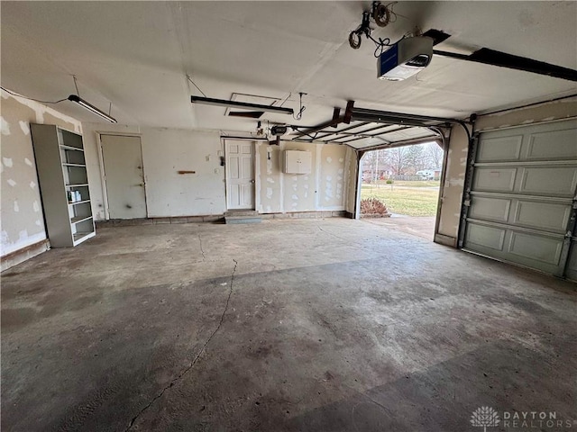 garage featuring baseboards and a garage door opener