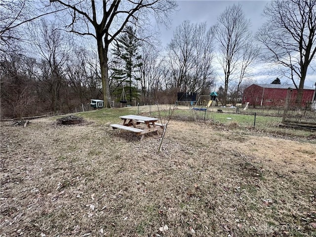 view of yard featuring a playground and fence