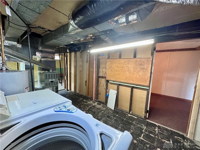 unfinished below grade area featuring heating unit, washer / dryer, and gas water heater