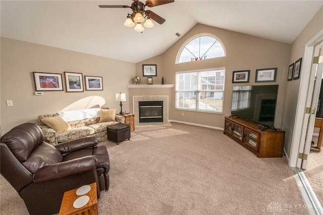 living area with high vaulted ceiling, a tile fireplace, light carpet, a ceiling fan, and baseboards