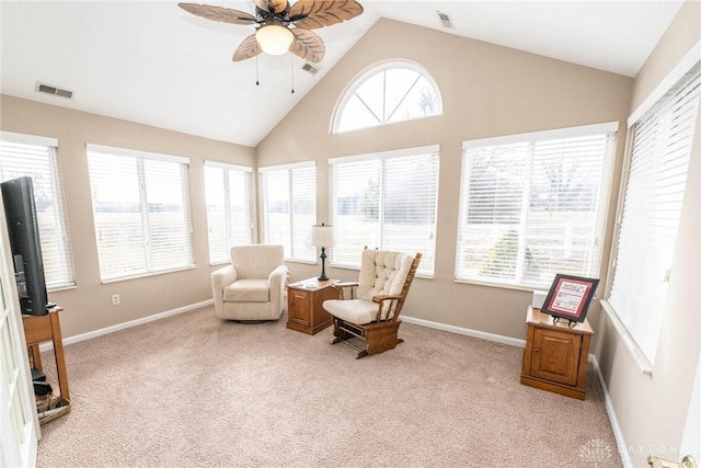 sitting room with baseboards, visible vents, a ceiling fan, and light colored carpet