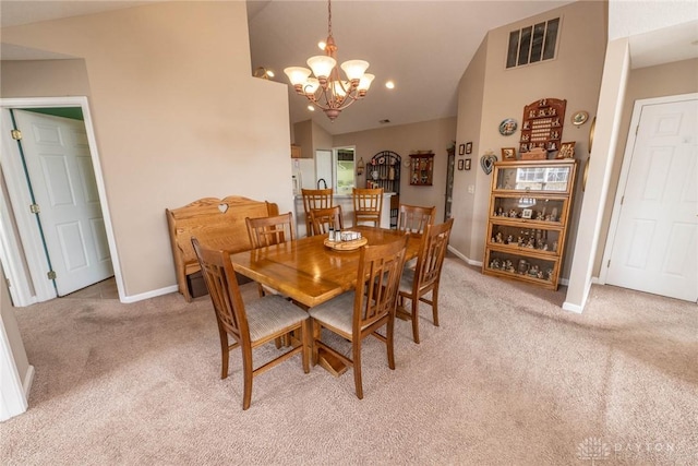 dining area featuring a notable chandelier, light colored carpet, visible vents, vaulted ceiling, and baseboards