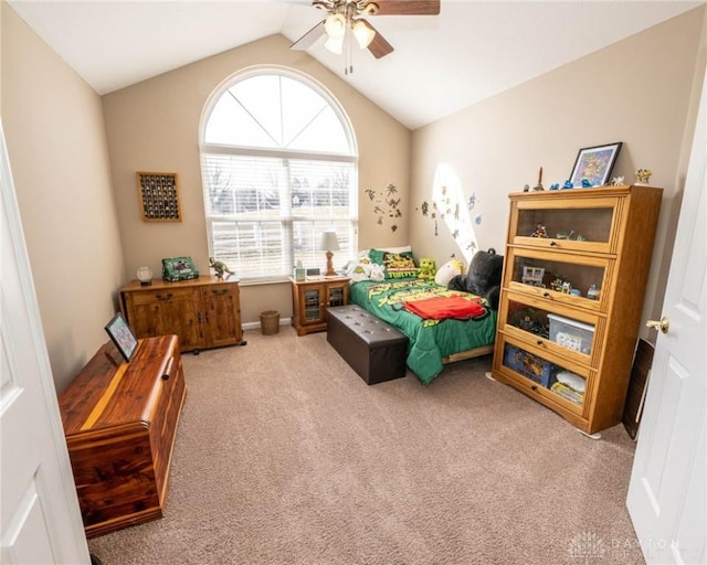 carpeted bedroom with a ceiling fan and lofted ceiling