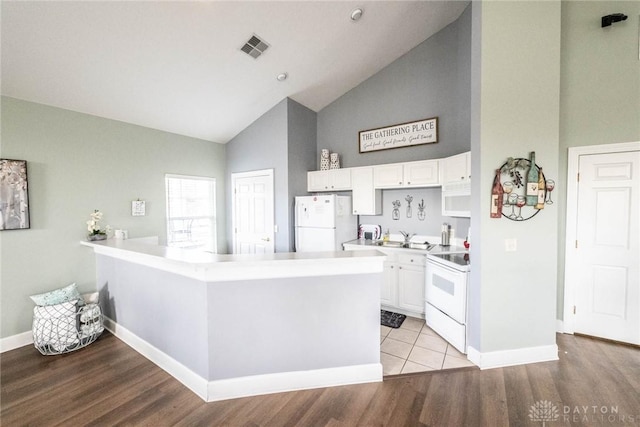 kitchen featuring white appliances, white cabinetry, visible vents, and light wood finished floors