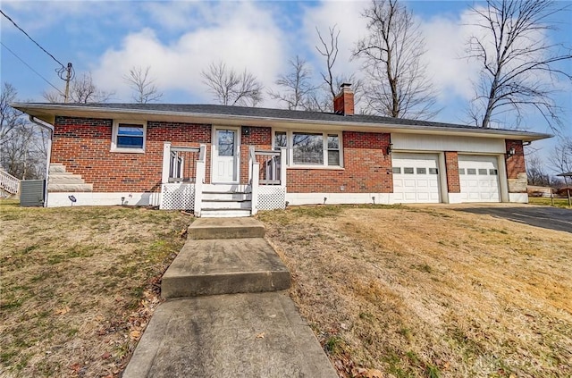 view of front of home featuring driveway, a garage, a chimney, and brick siding