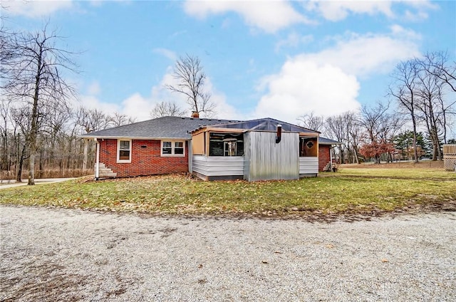 view of front of property with brick siding and a front lawn