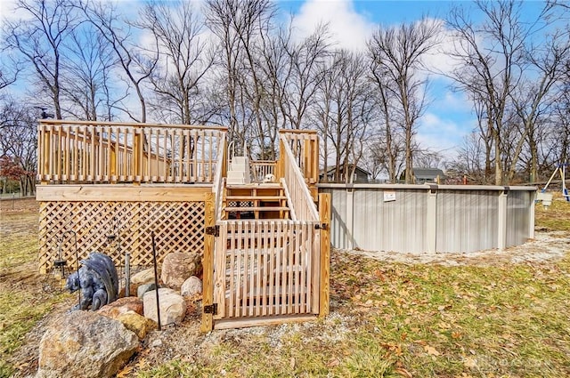 view of yard with a swimming pool and a deck