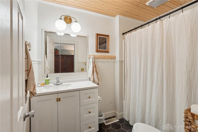 bathroom featuring a wainscoted wall, a shower with shower curtain, vanity, tile patterned flooring, and wooden ceiling