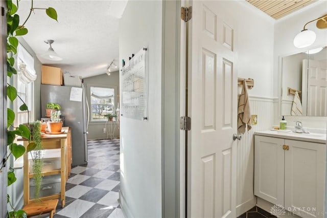 bathroom featuring wainscoting, vanity, and tile patterned floors