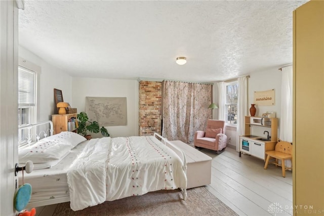 bedroom with a textured ceiling and hardwood / wood-style flooring