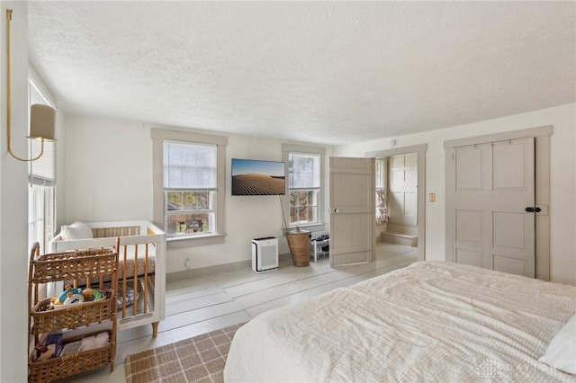 bedroom featuring a textured ceiling and baseboards