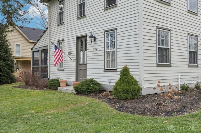 entrance to property with a lawn