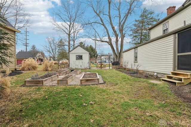 view of yard featuring entry steps, a storage unit, an outdoor structure, and a garden