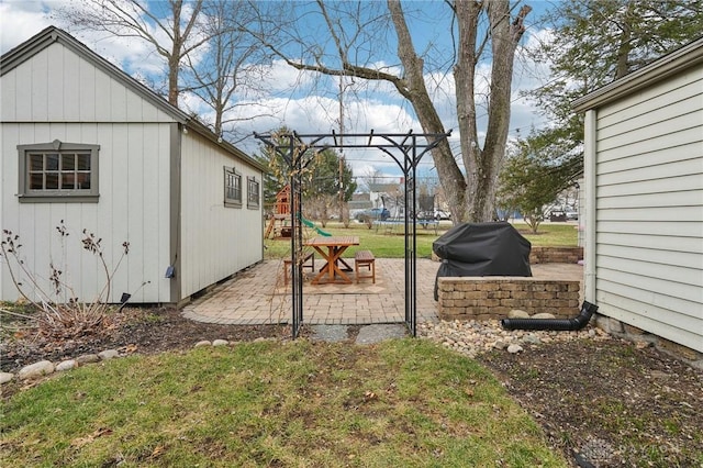 view of yard featuring a trampoline, a patio area, and a playground