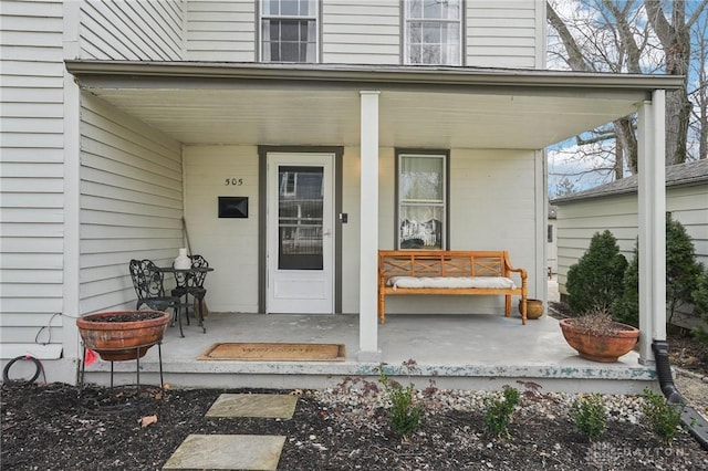 view of exterior entry with covered porch