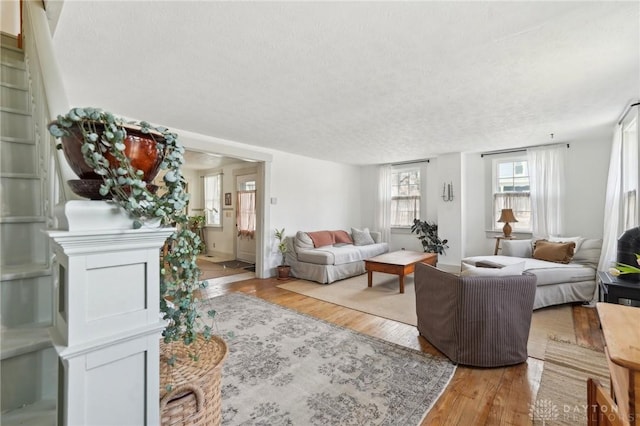 living room featuring hardwood / wood-style flooring and a textured ceiling