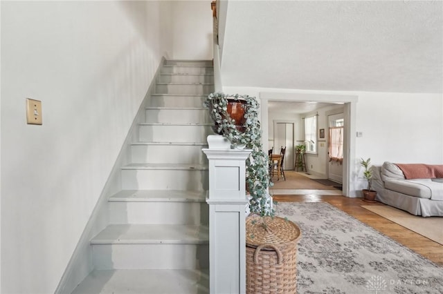 staircase with wood finished floors