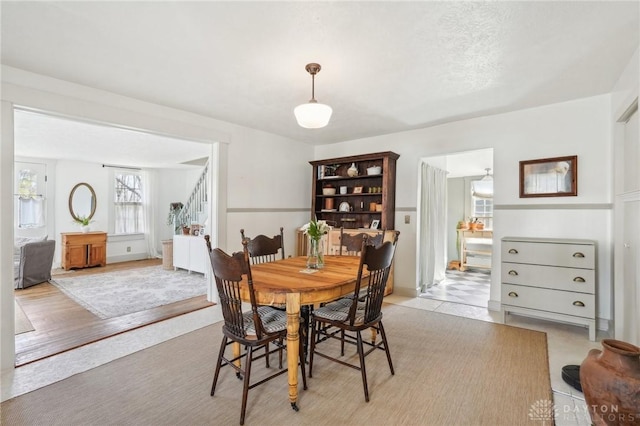 dining area featuring stairway