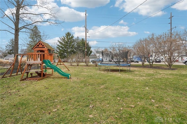 view of playground featuring a trampoline and a yard