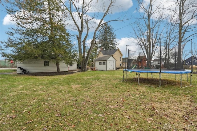 view of yard with a storage shed, a trampoline, and an outdoor structure