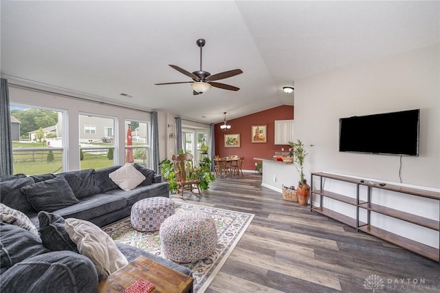 living area with ceiling fan, wood finished floors, visible vents, baseboards, and vaulted ceiling